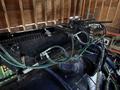 Close-up view of the hydraulic system of a 2018 Kenworth T800 showing hoses and components connected to the machinery