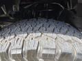Close-up of a rugged tire tread from a 2013 RAM 2500 showcasing deep grooves and a strong grip pattern