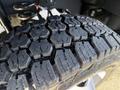 Close-up of a tire from a 2024 Ford F-550 showcasing a deep tread pattern designed for traction and performance