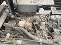 A 2010 Kubota RTV 900 engine compartment showing the engine, various hoses, and components with visible dirt and debris