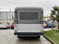 A gray 2020 Chevrolet Express van viewed from the rear with a smooth surface and two tail lights on either side