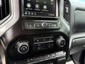 Interior dashboard controls of a 2019 Chevrolet Silverado 1500 featuring touchscreen display and climate control knobs