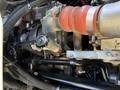 Close-up of the engine components of a 2009 International 3000 CE showing various hoses and pipes connected to the engine system