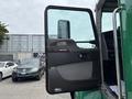 The image shows the open door of a 2013 Kenworth T370 truck revealing its interior features and control panel