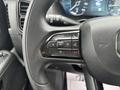 Close-up of the steering wheel controls of a 2023 RAM Promaster 3500 featuring buttons for navigation and phone functions