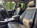 Interior view of a 2013 BMW X3 showing black leather seats with armrest and steering wheel in the foreground