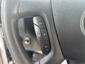 Close-up of the steering wheel of a 2020 Chevrolet Express showing control buttons for setting cruise control and adjusting speed