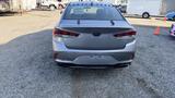 A silver 2018 Hyundai Sonata viewed from the rear showing its distinctive taillights and the car's sleek design.