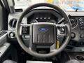 Steering wheel of a 2015 Ford F-350 SD with the Ford logo prominently displayed and controls on both sides