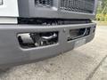 Close-up view of the front bumper of a 2018 Ford F-750 showing the grille and integrated features with visible mechanical components beneath the bumper