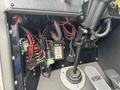 Close-up of a control panel featuring various wires and electrical components including a PDM-4 unit and a gear shift lever