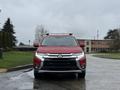 A red 2016 Mitsubishi Outlander parked facing forward with a sleek front design and chrome grille