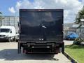 A 2017 Ford F-550 truck with a large dark box cargo area and a rear door, viewed from the back