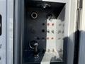 Control panel of a 2011 Freightliner M2 106 featuring various switches buttons and gauges for operating the vehicle and its systems