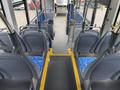 Interior view of a 2018 Grande West Vicinity bus showing rows of blue upholstered seats and a clear aisle leading to the front