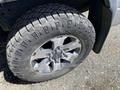 A close-up of a tire mounted on a 2014 Ford F-150 showcasing rugged tread patterns and alloy wheel design