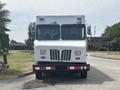 A white 2011 Workhorse W62 delivery truck with a boxy design and dual front windows is parked on a road