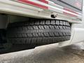 A close-up of a large tire mounted on the side of a truck showcasing its rugged tread and robust structure