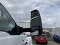 A 2019 Ford F-750 truck with a prominent side mirror showing its reflective surface and sturdy build