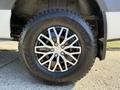 A close-up of a 2023 Mercedes-Benz Sprinter 2500 wheel showcasing a black and silver alloy rim mounted on a Goodyear Wrangler tire