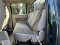 Interior of a 2008 Ford F-550 showing the rear bench seat with fabric upholstery and seatbelts