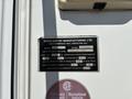 A metal identification plate for a 2018 Westland Travelaire listing model, serial number, date of manufacture, and specifications for camper equipment and refrigerator capacity