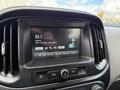The dashboard display of a 2018 Chevrolet Colorado showing radio station 93.7 and song information