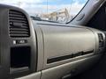 Dashboard of a 2013 Chevrolet Silverado 3500HD featuring air vents and a compartment with a textured finish