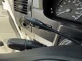 Close-up of the steering wheel controls in a 2017 Mercedes-Benz Sprinter including cruise control and wiper controls