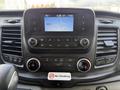 Dashboard of a 2021 Ford Transit featuring a touchscreen display controls for radio and climate with various buttons and knobs