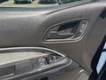 Interior door panel of a 2017 Chevrolet Colorado featuring a door handle and window controls