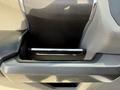 A console compartment in a 2018 Ford F-150 featuring a sleek black design with a chrome handle for opening and access to storage inside
