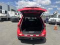 A red 2015 Jeep Grand Cherokee with the rear hatch open showcasing the spacious cargo area
