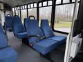 Interior of a 2013 Chevrolet Express with blue fabric seats and seat belts visible