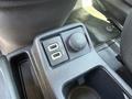 Close-up of a 2021 Ford Transit Connect center console with two USB ports and a 12V power outlet