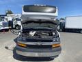 A 2020 Chevrolet Express van with the hood open revealing the engine compartment