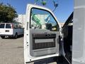 A 2011 Ford F-550 with an open driver's side door showing the interior door panel and handle