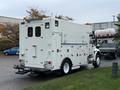 A 2011 International 4400 truck with a white body equipped for utility work featuring multiple compartments and warning lights on the roof