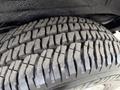 Close-up of a tire tread from a 2004 Chevrolet Express showing deep grooves and patterns designed for traction and stability on the road