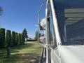 A 2012 Ford E-450 with a silver side mirror and a partial view of the front windshield