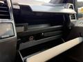 The image shows the interior dashboard of a 2020 Ford F-350 SD featuring an open glove compartment and storage area with various controls and textures