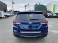A blue 2022 Chevrolet Equinox viewed from the rear showcasing its taillights and Chevrolet emblem