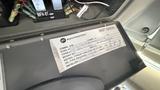 A label mounted on the interior of a 2021 Ford Transit detailing compressor information and service instructions