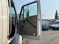 A 2006 Sterling Acterra truck with the driver's side door open showcasing a gray interior door panel and window