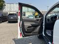 A 2017 Chevrolet Colorado with the driver's side door open showing the interior features and controls