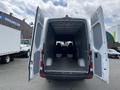 2025 Mercedes-Benz Sprinter with the rear doors open revealing an empty cargo area and two front seats visible in the cab