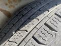 Close-up of a used tire showcasing tread patterns with visible wear indicators on the surface