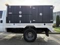 A 2015 Ford F-550 with a utility bed featuring multiple tool compartments and a black finish