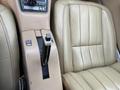 Interior view of a 1970 Chevrolet Corvette featuring beige leather seats and a console with a gear shifter