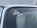 Close-up of a 2008 Ford Econoline windshield displaying a certificate of approval sticker with the year 2022 and a registration number